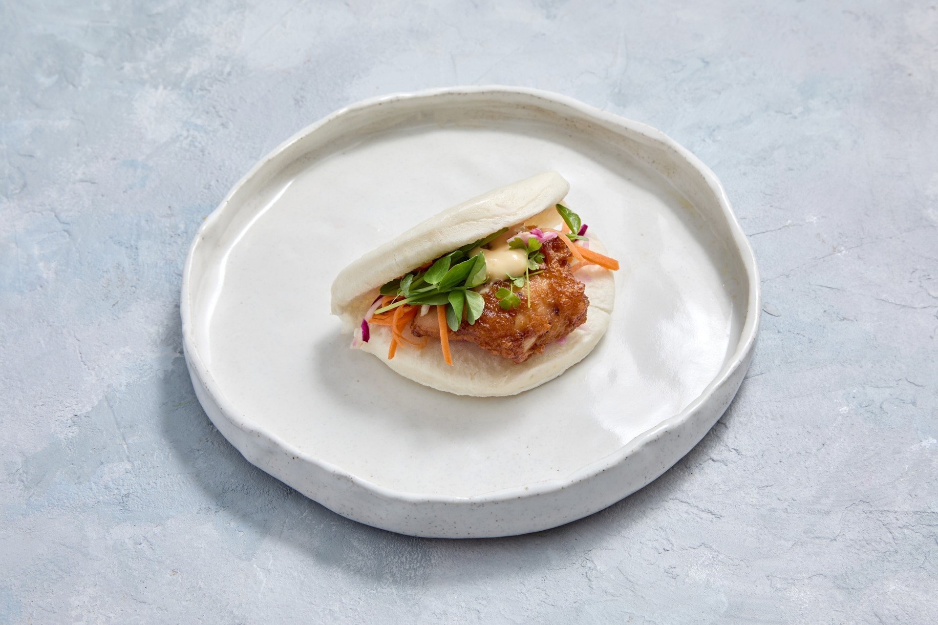 Substantial:  Kaarage Chicken Bao bun, Lemon Yuzu Mayo, pickled veg, snow pea, shredded carrot